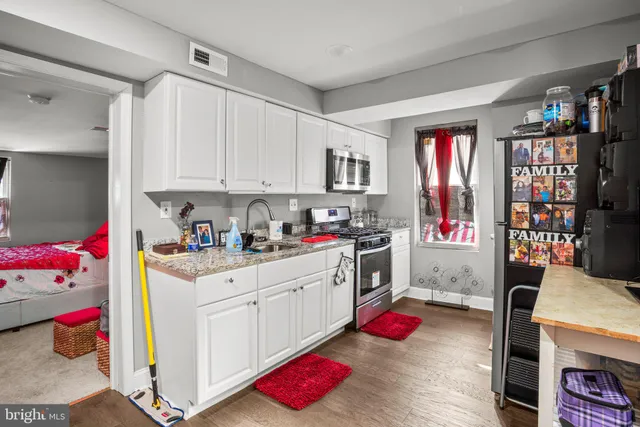a kitchen with stainless steel appliances granite countertop a stove and cabinets