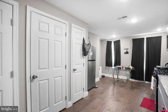 a bed sitting in a bedroom next to a flat screen tv