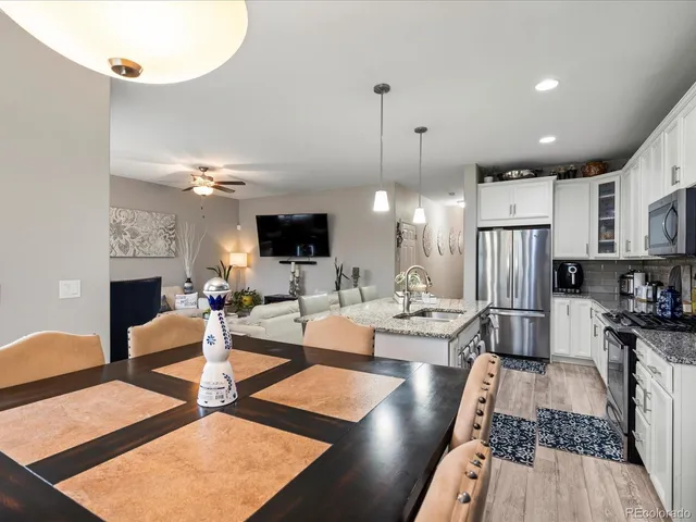 a kitchen with stainless steel appliances granite countertop a sink a stove and a microwave