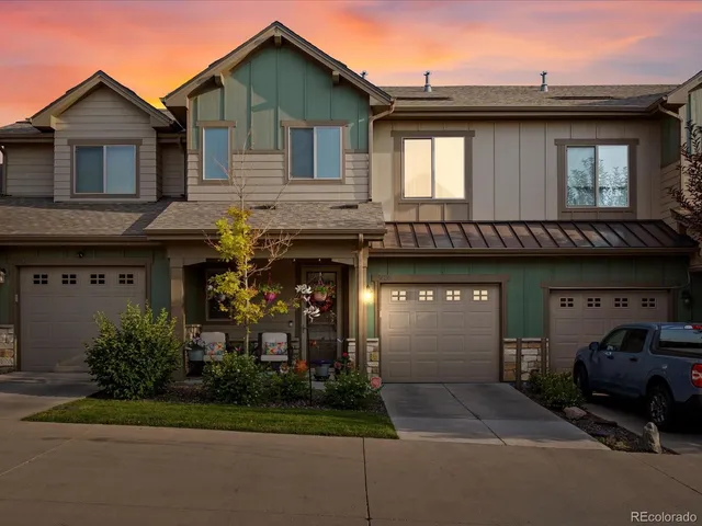 a kitchen with kitchen island granite countertop a sink cabinets and wooden floor