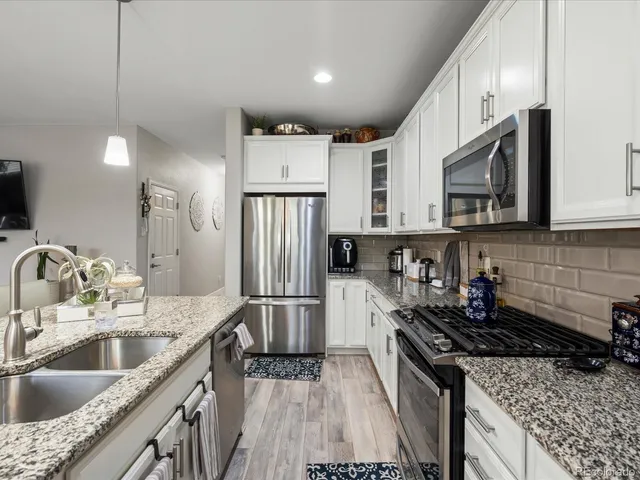 a living room with furniture and kitchen view