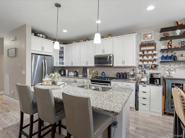a view of a living room kitchen and a wooden floor