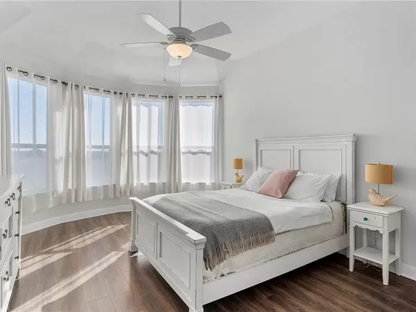 a bedroom with a large bed and a chandelier