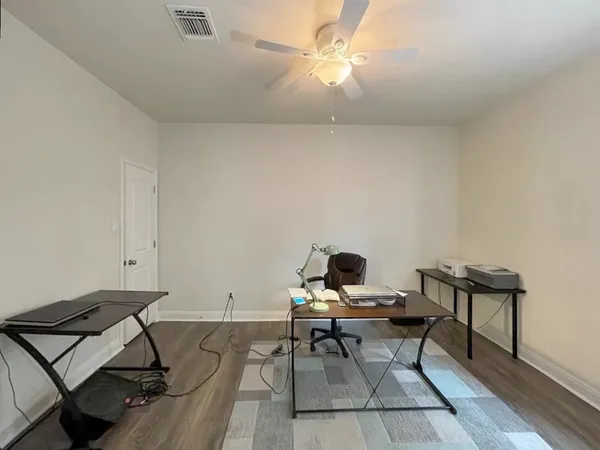 a living room with furniture and a rug