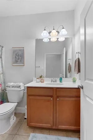 a bathroom with a sink mirror and toilet