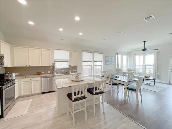 a kitchen with lots of counter top space and dining table