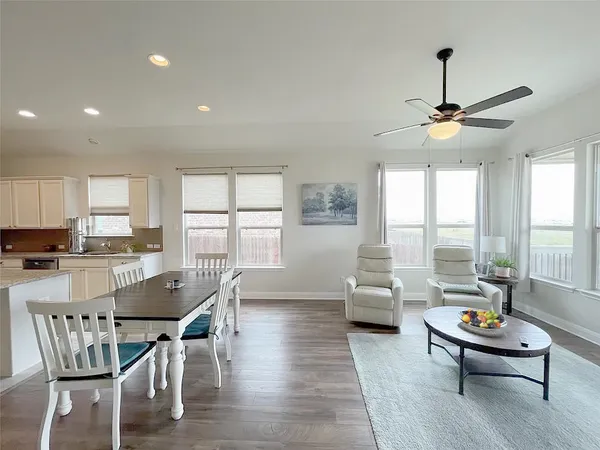 a living room with furniture a window and a chandelier