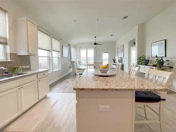 a kitchen with stainless steel appliances granite countertop a sink stove and wooden cabinets