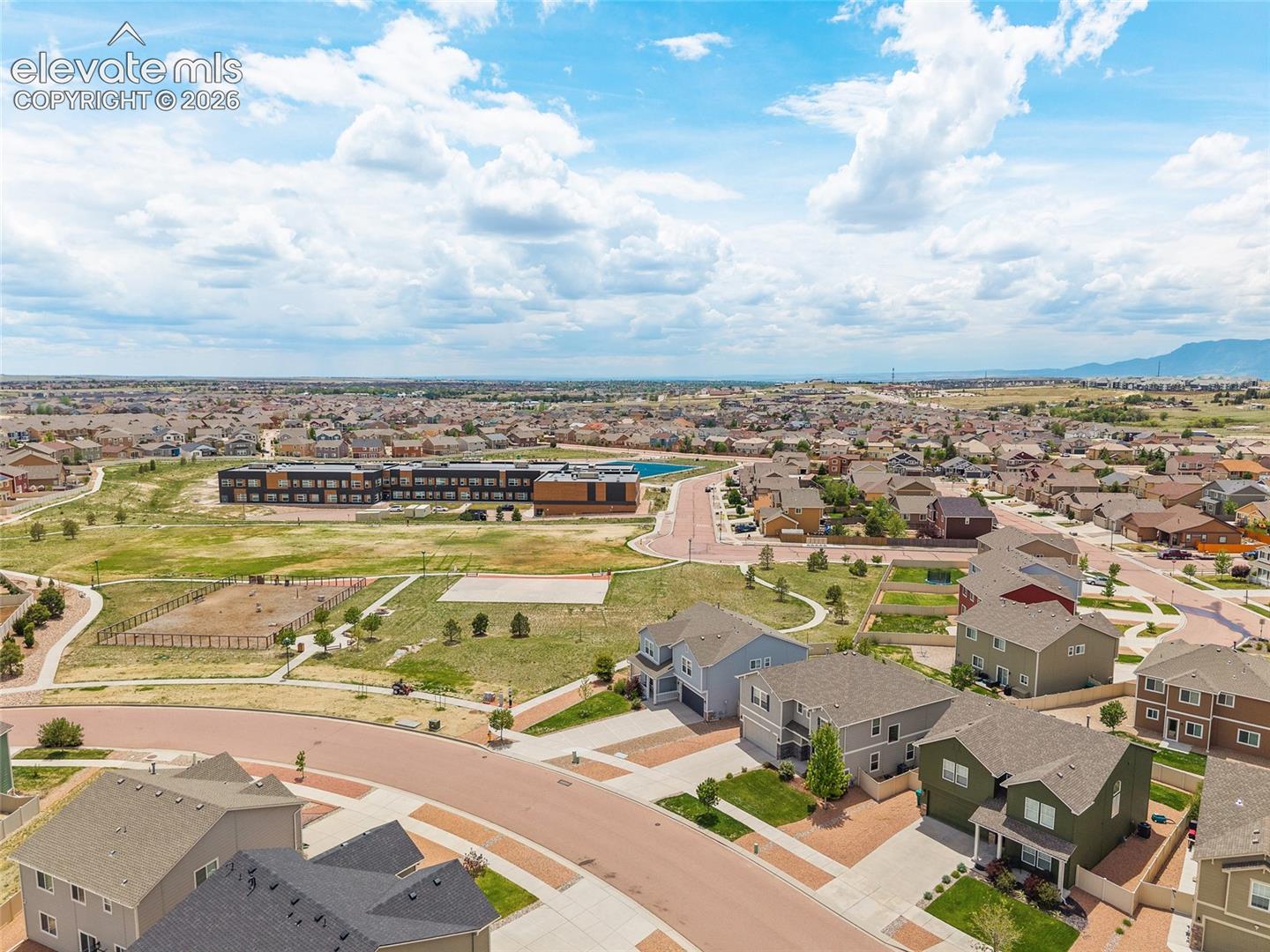 8675 Vanderwood Road Colorado Springs, CO 80908 - Photo 41 of 48 Aerial perspective of a residential neighborhood featuring detached homes with varied exterior finishes and attached garages