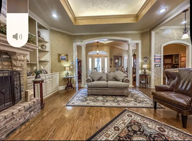 a living room with furniture and a fireplace