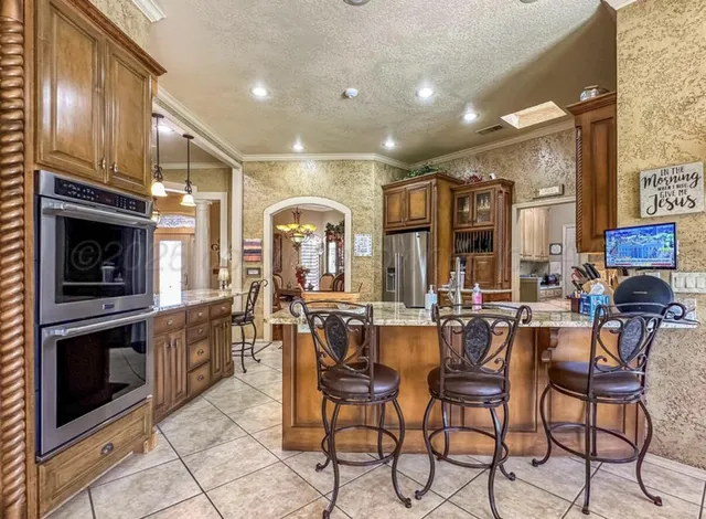 a kitchen with stainless steel appliances and cabinets
