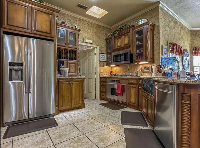a kitchen with granite countertop a stove and cabinets