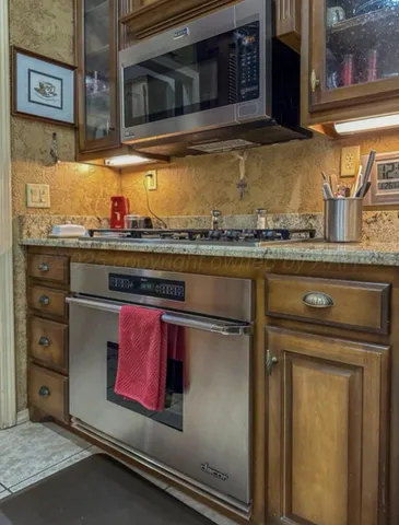 a kitchen with stainless steel appliances granite countertop a stove top oven island a counter top space and cabinets