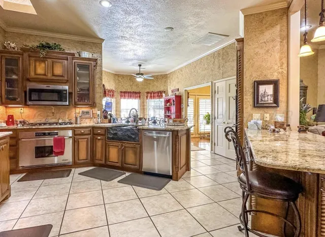 a view of a dining room with furniture and chandelier