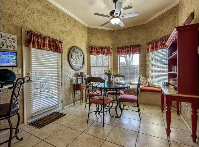 a dining room filled chandelier and wooden floor