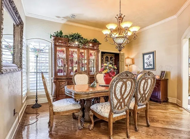 a view of a dining room with furniture and chandelier