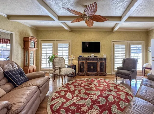 a bedroom with bed and a large window