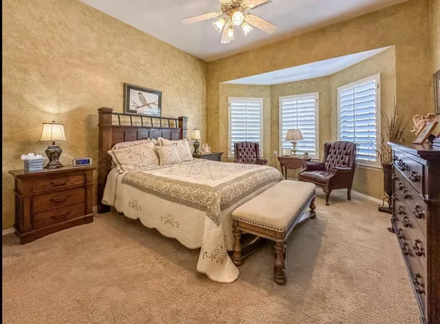a bedroom with furniture and a chandelier