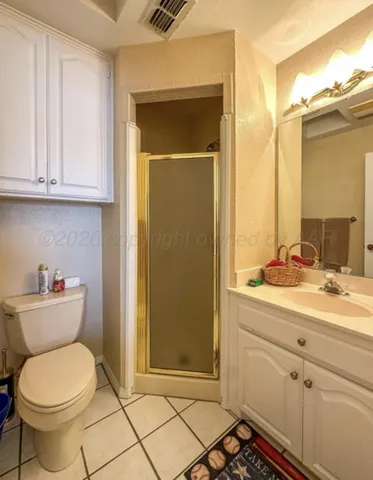 a backyard of a house with plants and large tree