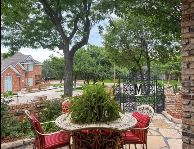 a view of a chairs and table in backyard