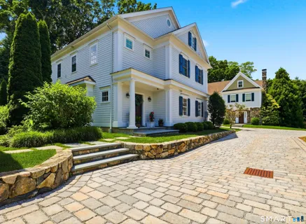 a front view of house with yard and green space