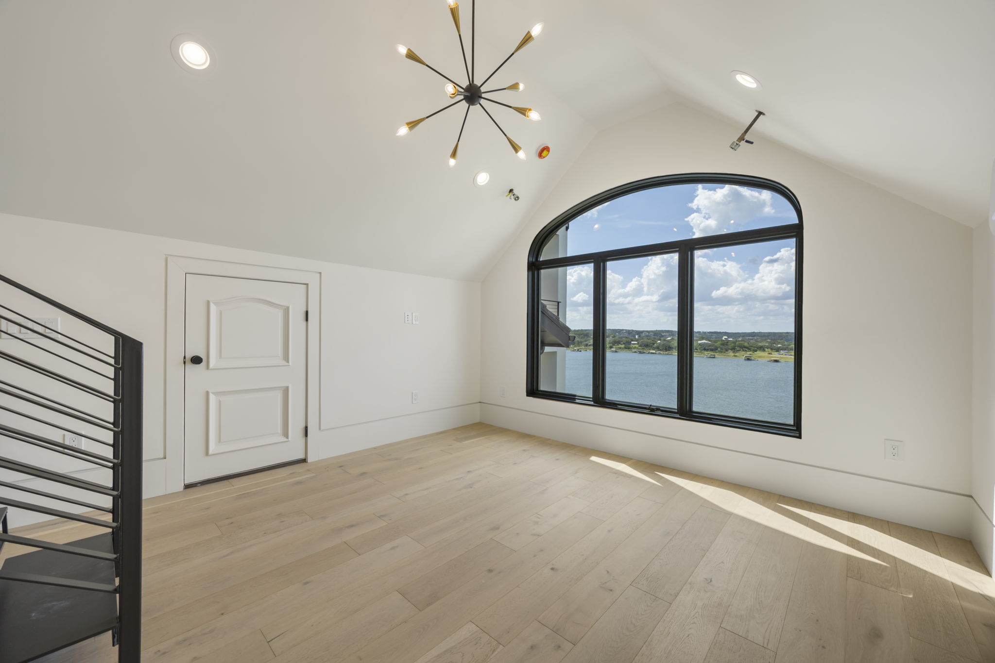 1496 Buffalo Gap Road Lakeway, TX 78734 - Photo 33 of 37 A top-floor bonus room with soaring vaulted ceilings and an expansive lake view from a large arched window.