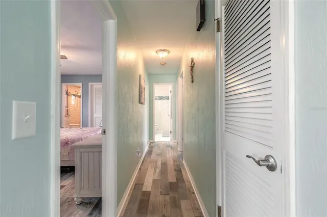 a view of a hallway with wooden floor