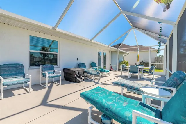 a outdoor space with patio the couches and pool table and chairs under an umbrella
