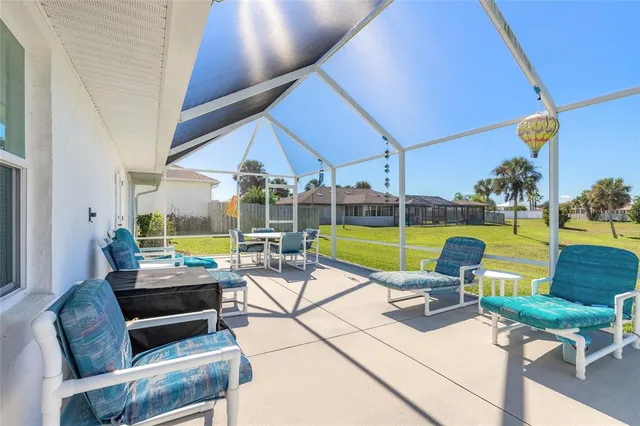 a building outdoor space with patio furniture and garden