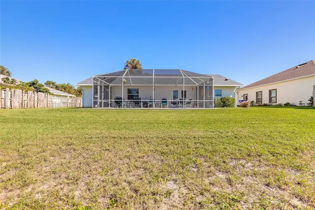 a view of a house with a yard and sitting area