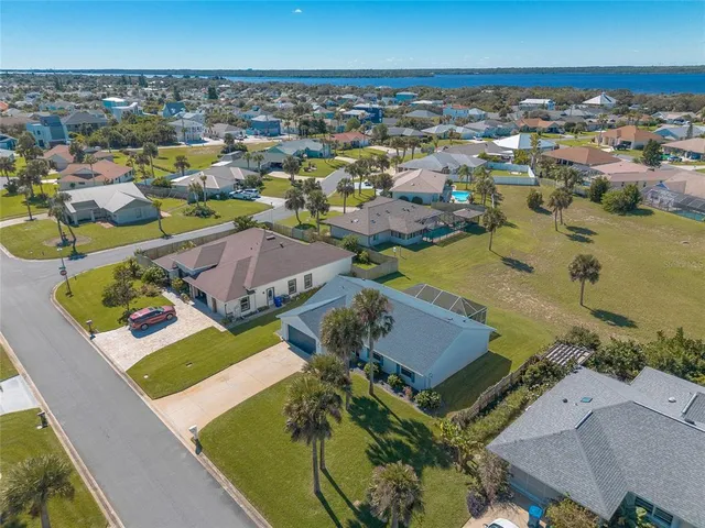 an aerial view of a house with a swimming pool yard and outdoor seating