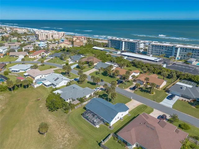 an aerial view of residential houses with outdoor space