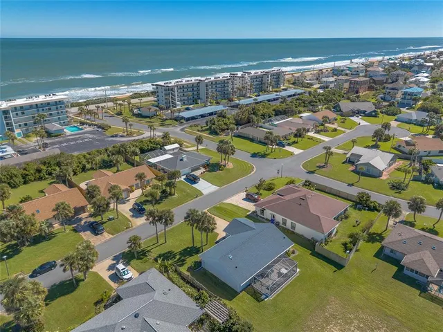 an aerial view of residential houses with outdoor space