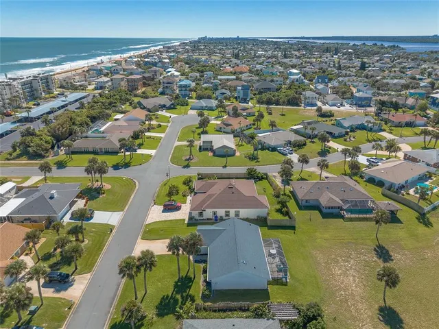 an aerial view of residential houses with outdoor space