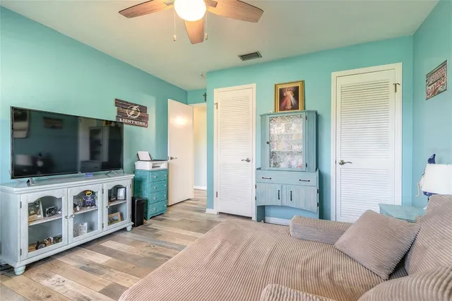 a bedroom with furniture and a flat screen tv