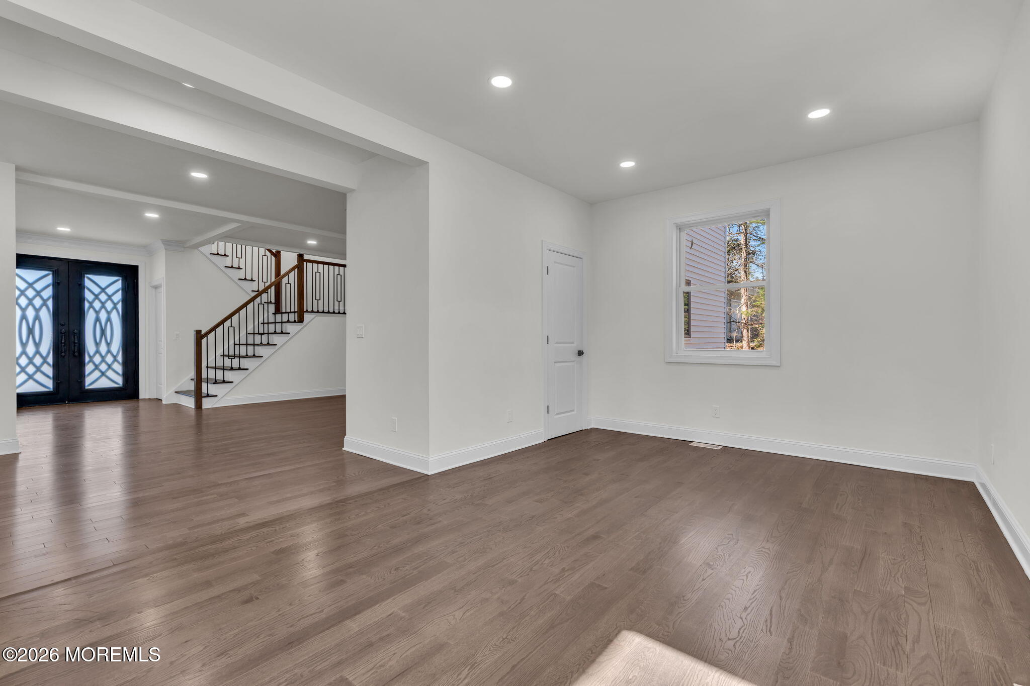 58 Fish Hawk Drive Middletown, NJ 07748 - Photo 11 of 33 a view of an empty room with wooden floor and stairs