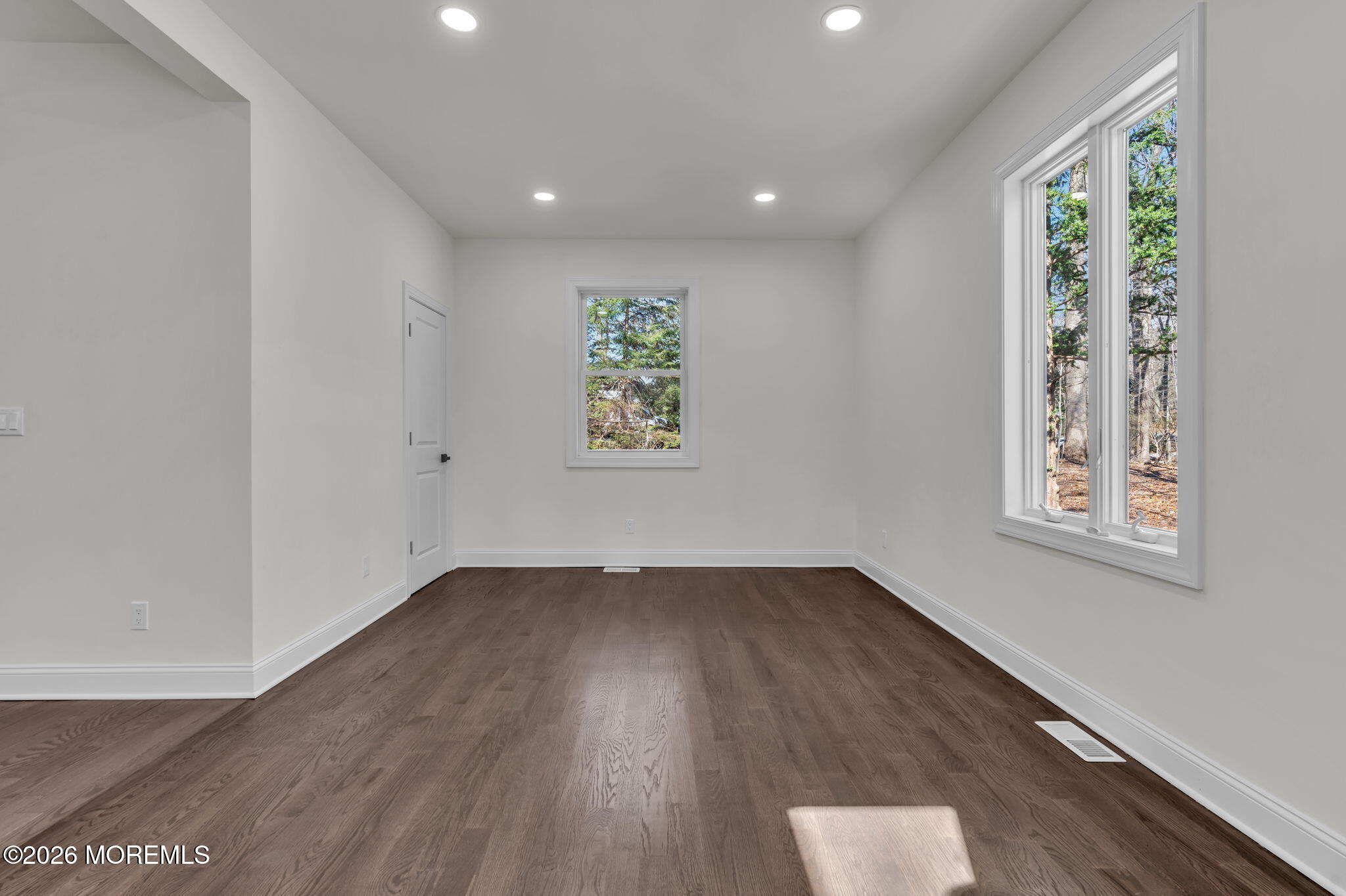 58 Fish Hawk Drive Middletown, NJ 07748 - Photo 12 of 33 an empty room with wooden floor and windows