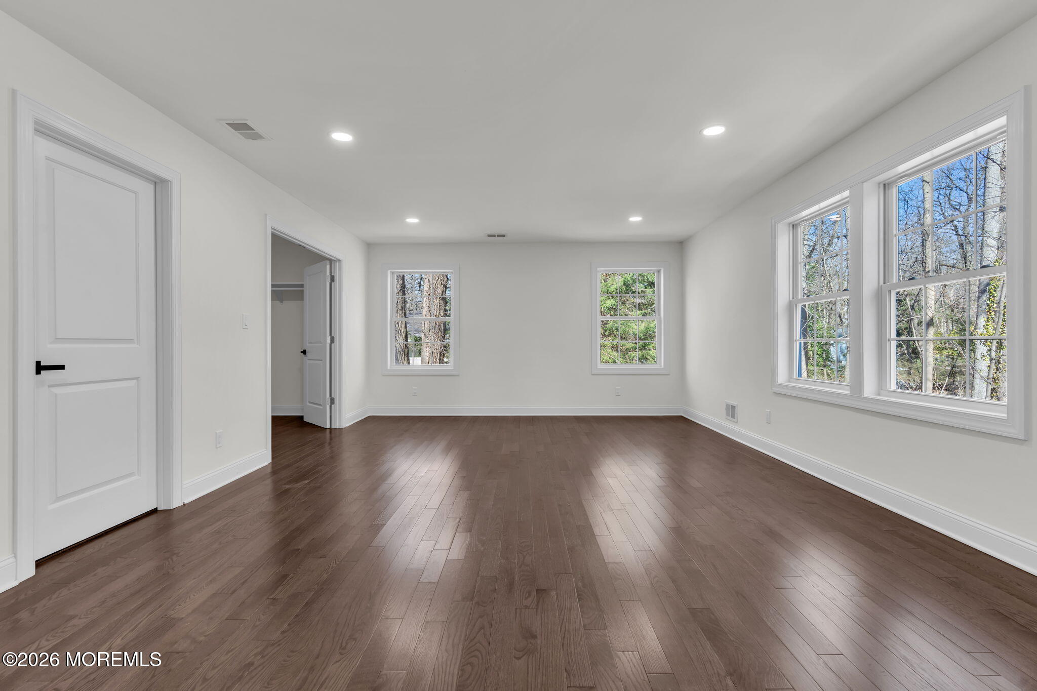 58 Fish Hawk Drive Middletown, NJ 07748 - Photo 14 of 33 an empty room with wooden floor and windows