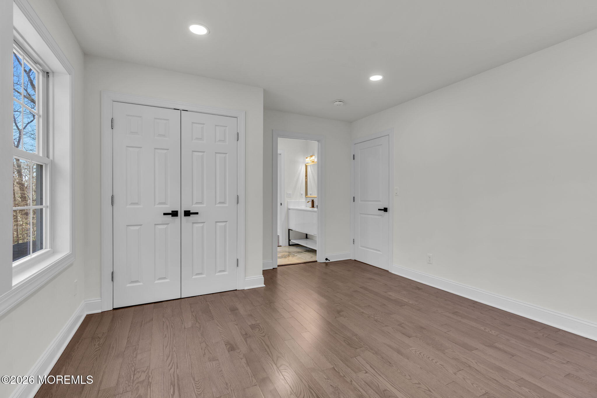 58 Fish Hawk Drive Middletown, NJ 07748 - Photo 17 of 33 a view of an empty room with wooden floor and a window