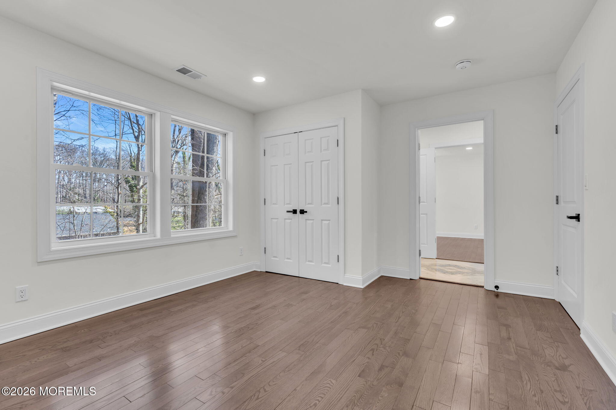 58 Fish Hawk Drive Middletown, NJ 07748 - Photo 19 of 33 a view of an empty room with wooden floor and a window
