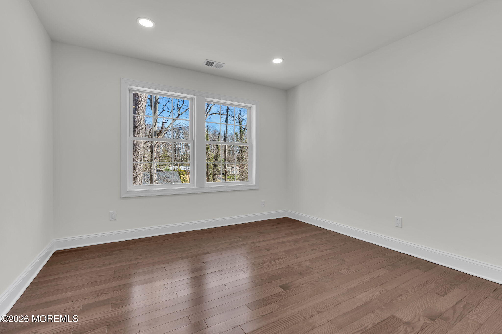 58 Fish Hawk Drive Middletown, NJ 07748 - Photo 21 of 33 an empty room with wooden floor and windows