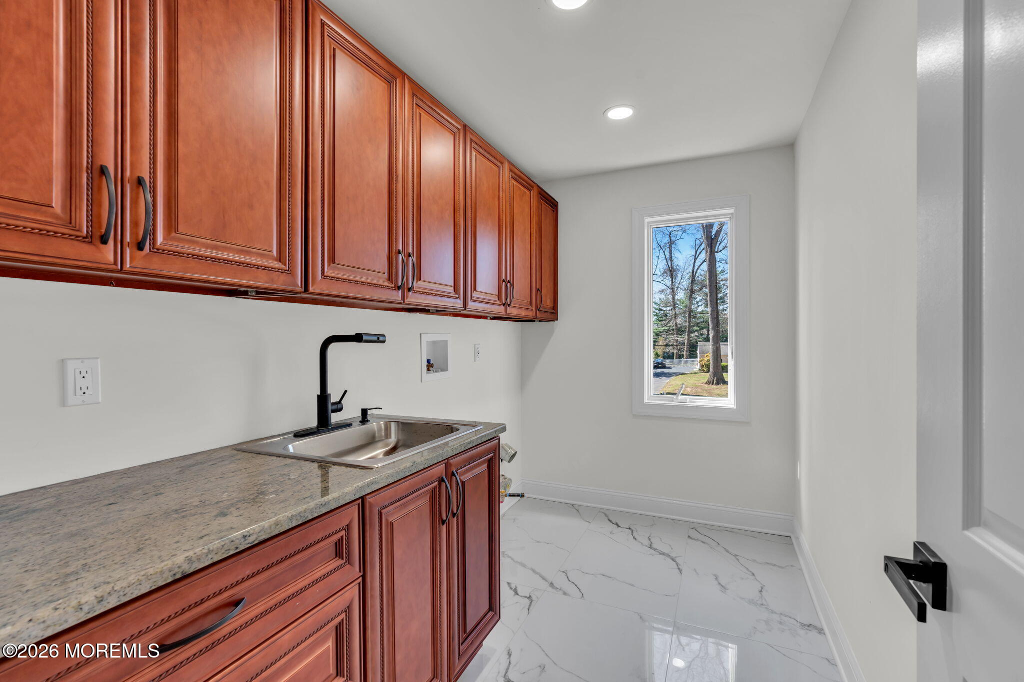 58 Fish Hawk Drive Middletown, NJ 07748 - Photo 22 of 33 a kitchen with stainless steel appliances granite countertop a sink a stove and cabinets