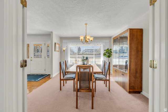 1060 West 2620th Street South Mapleton, UT 84664 - Photo 15 of 87 Dining space with a chandelier, a textured ceiling, and light carpet