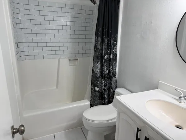 a bathroom with a sink a toilet and a bathtub
