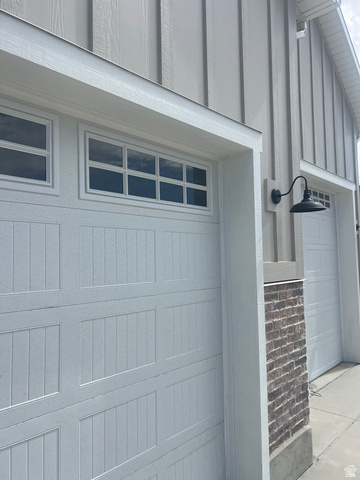 4740 West 25 North West Point, UT 84015 - Photo 14 of 15 White paneled garage doors with upper window inserts