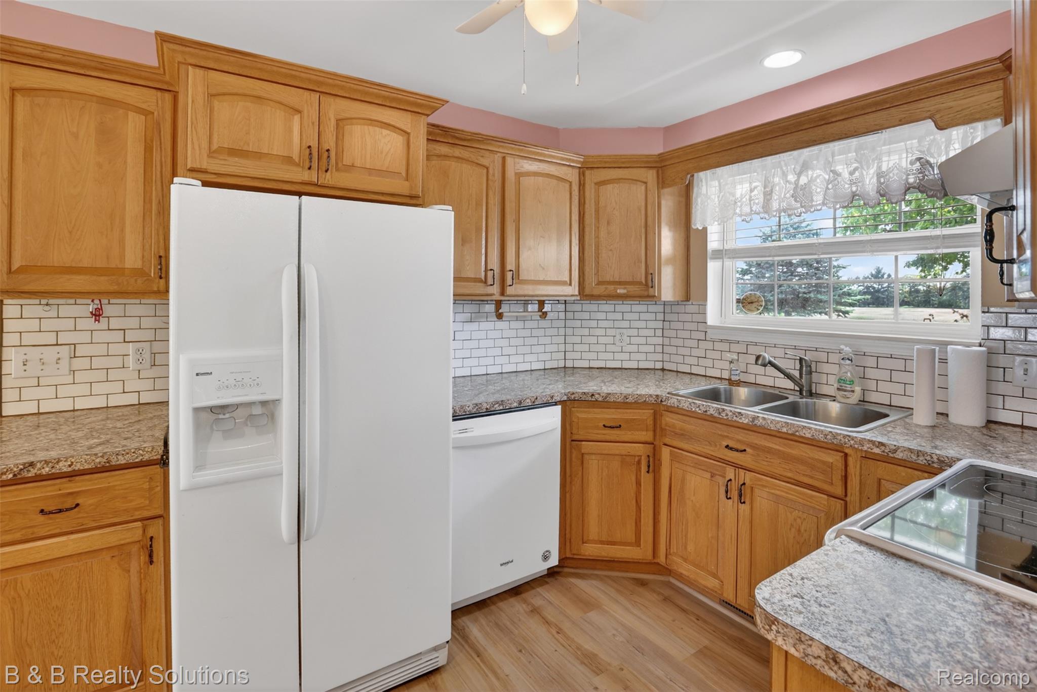 6100 Fish Lake Road North Branch, MI 48461 - Photo 6 of 45 Kitchen with white appliances, light wood-type flooring, and light countertops