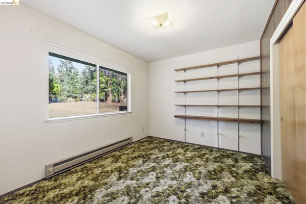a view of a room with window and cabinet