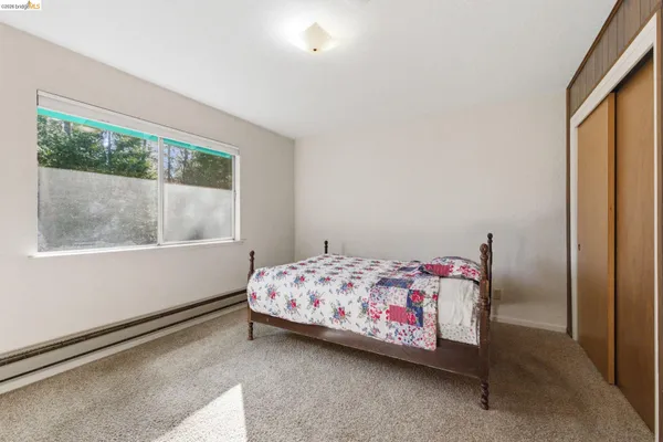 a bedroom with a bed and a window