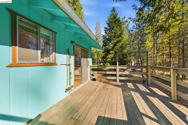 a view of balcony with a large window and wooden floor