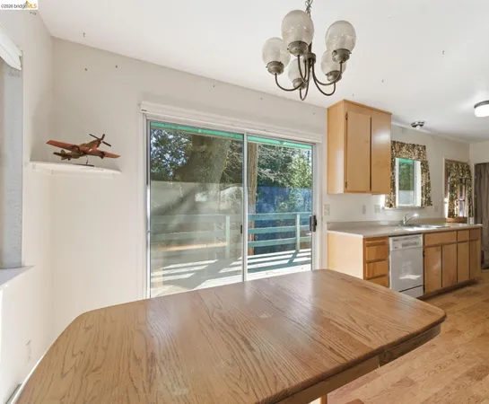 a kitchen with kitchen island a counter top a stove and a chandelier